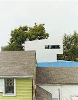 Though the Lowerline House may appear radically different, it deliberately mimics the neighboring shotgun camel-backs. The form is derived from a time when city taxes were based on the height of a building at the street front. To get more space but not get taxed, houses were built up on the rear of the property, problem solved.  Photo 8 of 11 in New Orleans, LA