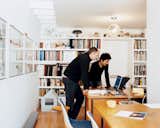 Office, Chair, and Desk Lit by the skylight and an Artemide ceiling lamp, Schenk and Ngai consult laptops on mid-century Heywood Wakefield desks, which Fernandez salvaged from a Harvard junkyard and then restored.  Photo 8 of 11 in New Beginnings