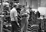 Charles Eames (right) visiting the Herman Miller factory, where the Eames Lounge and Ottoman has been produced since its 1956 debut.
