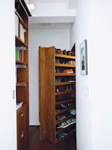 With space for shoes (the pair don’t wear any in the home), Rollerblading gear, umbrellas, and more, the deep entrance closet helps the couple maintain their minimalist interior. A hanging rod, made by Specialty Lighting, has an integrated light that turns on when the 200-pound door is opened. specialtylighting.com