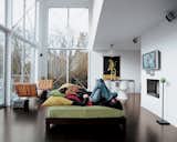 The couple lounges in their great room. The 16-foot-high windows are from Milgard.