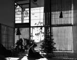 Ray Eames in the Eames House living room, Christmas 1949. The couple moved in on Christmas Eve with very little and furnished the home slowly over the ensuing decades. Photo courtesy the Eames Foundation.  Search “a-very-eames-christmas.html” from Ray Eames 101