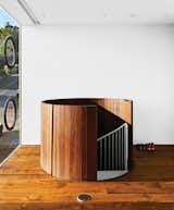 The trip from garage to first floor is through a wood-clad spiral staircase that resembles a giant slatted barrel.