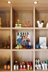 Montague arranges his objects with a sense of humor. Custom shelves display his collection of salt and pepper shakers.
