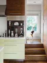 Dan Pacek and John Roynon of Leonia, New Jersey, expanded and renovated their tiny kitchen, integrating it more sensibly into their 1911 house while borrowing natural light from secondary sources, such as a window on the landing leading to the second floor.