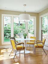 Dining Room, Pendant Lighting, Table, and Chair Counterweights Drum pendant lamp by George Kovaks from Lumens hangs above a Docksta table from Ikea.  Search “obsessed designer fills her home vintage finds” from Cramped Kitchen Transformed Into an Inviting Hub