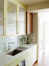 Much of the cooking and cleaning takes place at the rear counter, which is outfitted with an Evoke faucet by Kohler.  Photo 4 of 10 in Bay Ho Home by Haley Munro from Cramped Kitchen Transformed Into an Inviting Hub