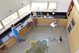 The kitchen from above, looking down from the second floor. Jody Beck with hudband Ross-Alan Tisdale, partners in Traction Architecture, with their kids Robin and Jonah.  Photo 6 of 10 in Angular Modern Beach House in Florida