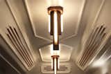 A custom light hangs from the beveled plaster ceiling.