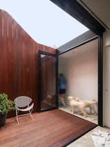In the courtyard, the fence line climbs upward, drawing the eyes to the clouds.  Photo 16 of 47 in 40+ Best Modern Courtyards by Zach Edelson from Renovated 19th-Century Terrace House Merges with the Outdoors