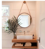 A porthole mirror and wood vanity deliver this bathroom, posted by @nossolar91, a slightly historical charm.