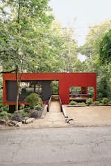 A bridge spans the home’s steep site for street access.
