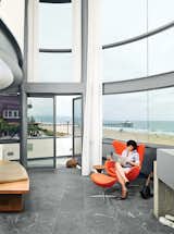 Dukes, who was hands-on with the redesign, sits in an Arne Jacobsen Egg chair in the living area.  Photo 3 of 6 in Revamped Beach Houses by Robert Gordon-Fogelson from A Renovated Ray Kappe Abode in Manhattan Beach