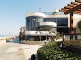 The glass-walled facade faces the Strand.  Photo 7 of 8 in Imaginative Round Homes by Robert Gordon-Fogelson from A Renovated Ray Kappe Abode in Manhattan Beach