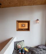 On a lakeside plot outside Toronto, four friends forge a new kind of vacation house. Here, a loft and a book provide plenty of entertainment. Photo by Lorne Bridgman.