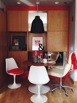 In the one-bedroom suites, wall storage, bookshelves, a dining table, and a Vespa chair by Bel & Bel add to the relaxed, cheerful vibe. The room also sports a leather Poltrona Frau and red Artemide lighting.