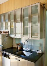 Kitchen, Undermount Sink, and Metal Cabinet Garber and Robertson replaced walls and doors with translucent Panelite, which draws sunlight deep into the apartment.  Search “backsplash” from Bright Renovation of a Tiny Manhattan Apartment