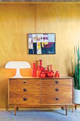 A vintage chest of drawers supports the playful forms of a Nesso lamp, designed by Giancarlo Mattioli for Artemide, and a collection of Holmegaard ceramics.