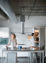 In Chicago’s Lower West Side, editorial director Chelsea Jackson and and her chef husband Arthur renovated their fourth-floor condominium to include a custom Bulthaup kitchen. "We wanted to find a kitchen island that would be light enough to make the room seem large while still standing up to heavy-duty cooking," Chelsea notes. Calls to kitchen retailers were fruitless until Arthur reached the Bulthaup showroom, where the staff suggested he come check out a floor model of the discontinued System 20 kitchen. The stainless steel island, with its precise profile and gas cooktop, was exactly what the couple was after, and they bought it on the spot. A full Bulthaup kitchen—completed with components from the B3 range—would soon become the centerpiece of their new home.