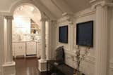 The entirety of the private space is set with dark hardwood floors and includes an elevated sleeping area, living room, bathroom, dressing area, office, and kitchen. Photo by Brittany L. Kimmel.