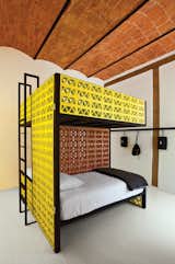 Splashy bunk beds made from yellow lattice brick outfit this stylish hostel in Mexico.
