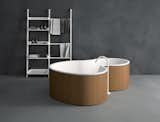 The DR tub by Marcio Kogan for Agape is made from curved wood on the outside and solid-surface on the inside with taps that can be installed on the wall or floor.  Photo 1 of 1 in Brazilian-Influenced Organic Modern Bathtub for Italian Company Agape