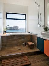 Bath, Drop In, Vessel, Medium Hardwood, Open, Recessed, and Full The residents, who previously lived in Japan, asked that the bathroom be modeled after a Japanese-style bathhouse. Wood-effect porcelain tiles from Ariostea line the shower and tub area.  Bath Drop In Vessel Open Photos from A Dramatic Cliffside Prefab Steps From the Beach in Australia