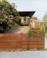 Trellis-like balcony railing cue the exposed timber frame extending over the house. The balcony and fence are made from sustainably harvested ipe wood.  Search “california” from Sustainability in Stages