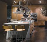 Arclinea's Lignum and Lapis kitchen system features green materials, professional-grade appliances, and advanced technology like a miniature greenhouse for growing herbs indoors and a retractable glass hood over the cooktop.