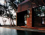 For architect Bijoy Jain, principal at Studio Mumbai Architects, making the most of the muggy locale meant foregoing walls for louvers and slatted sliding doors—and opting for local materials to construct the airy home. “Response to weathering is critical along the seaside,” he explains. The East Indian laurel, Burma teak, and palmyra woods will endure the seaside climate with an oiling after each monsoon. The pool that runs between the two structures of the home contrasts the choppy white-capped ocean with tranquil charm, making it a favorite spot for the vacationing family of four, who spend weekends here at the retreat.  Photo 1 of 7 in Far East: Architecture in India by Olivia Martin from Wood-Clad Seaside Retreat in India