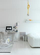 A brilliant white floor allows the smallest hints of neon color to pop in this Scandinavian bedroom. Bright white makes even small rooms look spacious, and employing one color throughout keeps costs down for a bedroom overhaul. (For this 660-square-foot apartment in Helsinki, designer Susanna Vento renovated the entire space for less than $4,000.) Photo by Petra Bindel.