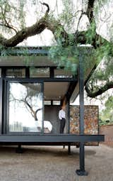 Exterior, House Building Type, Metal Roof Material, and Metal Siding Material Architect Georg van Gass adds a delicately poised cantilevered exterior wall that appears to slice the deck in half. Photo by: Elsa Young  Photo 5 of 8 in Idiosyncratic Bedrooms by Kelsey Keith from A Mies van der Rohe-Inspired Cottage in Johannesburg