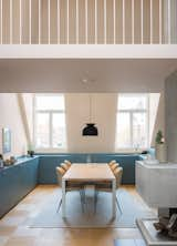 To inform the color palette for this interior renovation in Stockholm, NOTE Design Studio began with three inspirational images. “We let our gut feelings lead us,” says architect Susanna Wåhlin. They chose a picture of a woman in a cashmere coat (for its softness and style), a plaza in Rome (for its timelessness), and a pair of sand-colored sneakers (for its laid-back connotation). The palette is apparent in the kitchen, where a STRIPE rug from Kinnasand accents the family’s dining table, framed by chairs and a hanging lamp by Gubi.  Photo 1 of 2 in Loft by Marissa Hanim from There's Not a Single White Surface in This Comfy Stockholm Loft