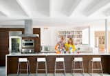 Armed with a keen eye for design and a yen for vintage furniture shopping, Glee star Jayma Mays and actor Adam Campbell revitalize a formerly jumbled Los Angeles house. The once-hermitic kitchen now has a direct view of the patio and pool. The hood is by Zephyr, the cooktop is by Miele, the refrigerator is by Sub-Zero, the ovens are by GE Monogram, and the stand-mixer is by KitchenAid. The Sebastian barstools and Trådig fruit bowl are also from Ikea.&nbsp;