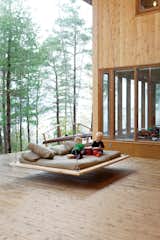 Outdoor, Large Patio, Porch, Deck, and Wood Patio, Porch, Deck Two-year-old Annika and five-year-old Soren make music on the "nap swing," a popular hangout spot for kids and adults alike.  Photos from Four Friends Joined Forces to Realize This Idyllic Forest Retreat Outside Toronto