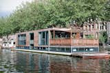 Exterior, Flat RoofLine, Boathouse Building Type, and Wood Siding Material The couple plan to add a kitchen garden to the platform just below the terrace that connects to the kitchen.  Photo 4 of 4 in A Live-In Kitchen on a Houseboat in Amsterdam