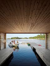 Outdoor, Small Patio, Porch, Deck, and Wood Patio, Porch, Deck The view from inside the Floating House's boat dock.  Search “rock boat” from A Floating House on Lake Huron Stands Out By Blending In