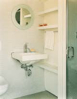Bath Room, Wall Mount Sink, and Mosaic Tile Wall In the guest bathroom, penny tiles were chosen “because they’re incredibly economical, utilitarian, and we liked their kitschy feel,” explains Gaffney.  Photo 1 of 1 in Bathroom inspiration by TravelFund by Siriusdan from Leave it to Beavers