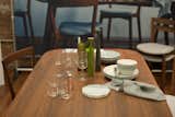 The Dwell Store is showcasing a dining room vignette, featuring modern tableware and furniture available in the store.