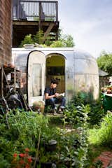 The Airstream is tucked into the back garden of a Berkeley co-op. "Having a garden at my footsteps and chickens just over the fence make it feel peaceful and private," says architect and resident, Andreas Stavropoulos. Photo by: Mark Compton