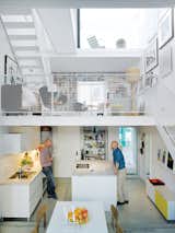 Three thin slabs have been staggered vertically through the space to create three distinct floors and allow light to flood in from the front, back, and roof. The white Saari kitchen makes the most of a compact space.