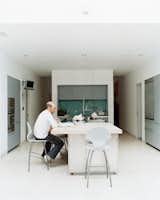 To avoid formality, Phillips created a different environment for each room. The kitchen, for example, is understated by virtue of its simple cabinetry by Boffi, and its white walls that flow with the rest of the house. “What we love about living here,” says Judith, “is that it works well with our young family. There is plenty of daylight, all the latest technology, and we don’t have to worry about sticky fingers destroying anything.”  Photo 6 of 10 in Victorian Secrets
