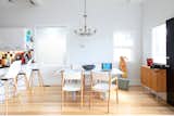 Designer and Photographer in Calgary, Alberta, Canada

"My small home includes this dining area. I chose a traditional bronze chandelier for the space to contrast with my modern look. It's a fixture I can live with for a very long time. The dining table is custom. I designed and had a family member weld the workbench-style base and had a marble remnant cut to fit for the table top. It's a heavy piece and the weight of it brings attention to my ash floors. The small credenza was custom made for this space by Speke Klein in Canada (to hold shoes, actually). My dining chairs are oak and leather from De La Espada and the swivel fibre glass bar stools from Modernica. I've added a tiny punctuation of a framed film photograph of my husband between the windows for fun."