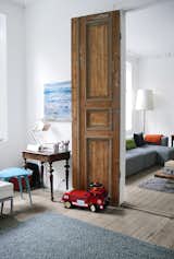 The goal of the renovation was to get the most out of every square inch, since there was no way to expand beyond the apartment’s historic envelope. Always-open double doors—stripped down to their original wood—connect the railroad-style parlors to create an open, loft-like feel.