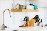 C & G Construction made the kitchen shelving from reclaimed cypress not used in the siding and decking. The White Cliff countertops are from Cambria, and the faucet is from Ikea.  Photo 9 of 12 in A Versatile House Fulfills All This Musician's Needs