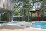 During Webber + Studio's renovation and expansion of a midcentury home, the architects sought to imbue a sense of "wabi-sabi," or imperfection in beauty, with an irregularly shaped pool and dappled light that's provided by a nearby tree. Large stepping stones and a garden gate also reference Japanese elements.