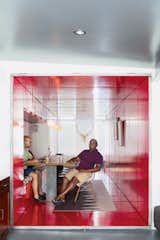 By inserting a tunnel made from 36 reclaimed commercial doors and tearing down a handful of walls, LOT-EK and contractor Andreas Scholtz brought light into the formerly unused dark hallway in Maurice Russell (right) and Jorge Fontanez’s apartment. The glossy Safety Red paint by Benjamin Moore catches the light by day but "becomes a richer, darker, very relaxing red at night," Fontanez says.