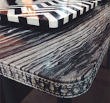 Bethan Gray is a materials mastermind. Striated quartzite top table with routed patterning along the edge.