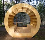 This outdoor bench-bibliotheque brings new meaning to the phrase ‘surrounded by books.’ Promising to bring intellectuals outdoors, this gazebo features a small table for lunch or tea, and easy-to-clean slatted wooden floors. Photo courtesy of Ruetemple Architectural Studio.  Photo 7 of 9 in Innovative Outdoor Libraries in Russia by Jacqueline Leahy