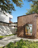 Outdoor, Walkways, and Side Yard In consultation with the clients, Alterstudio opted to clad the house in local cypress rather than imported, FSC-certified ipe.  Photo 1 of 48 in Austin Dwellings by TimberTown from A Sensitive Modern House in Austin, Texas